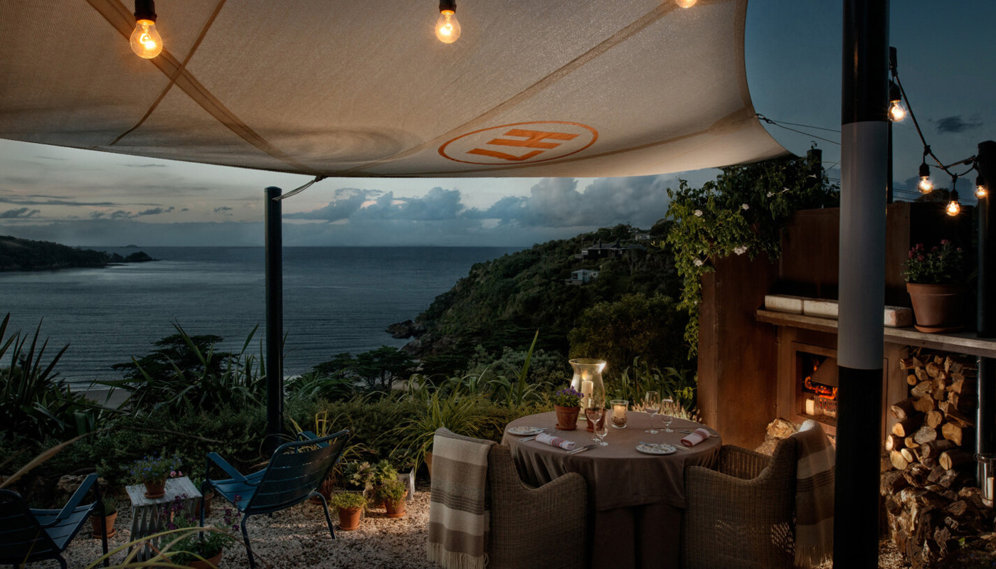 Luxury lodge overlooking the ocean at sunset on Waiheke Island