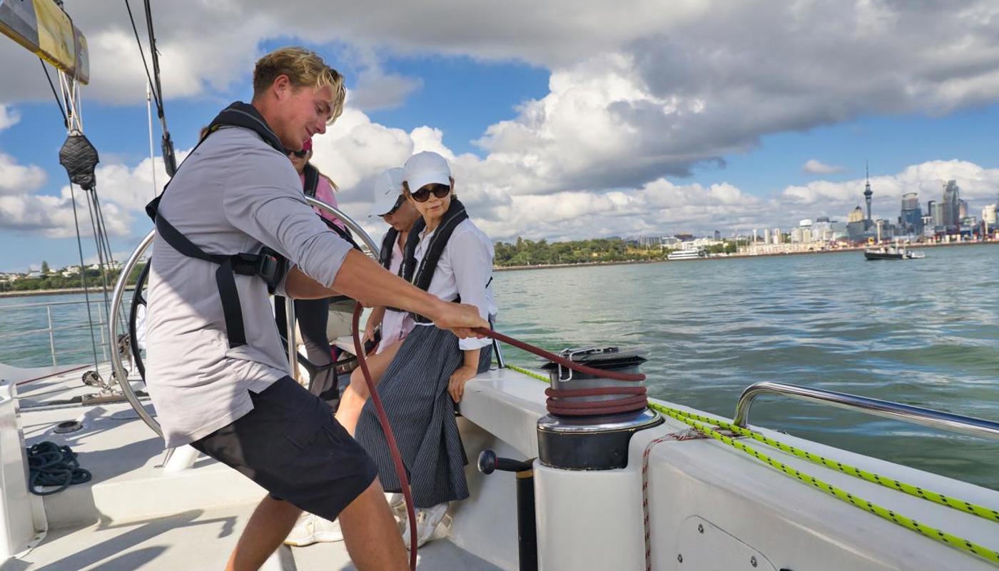 Crew on the winch onboard an America's Cup Sailing Experience