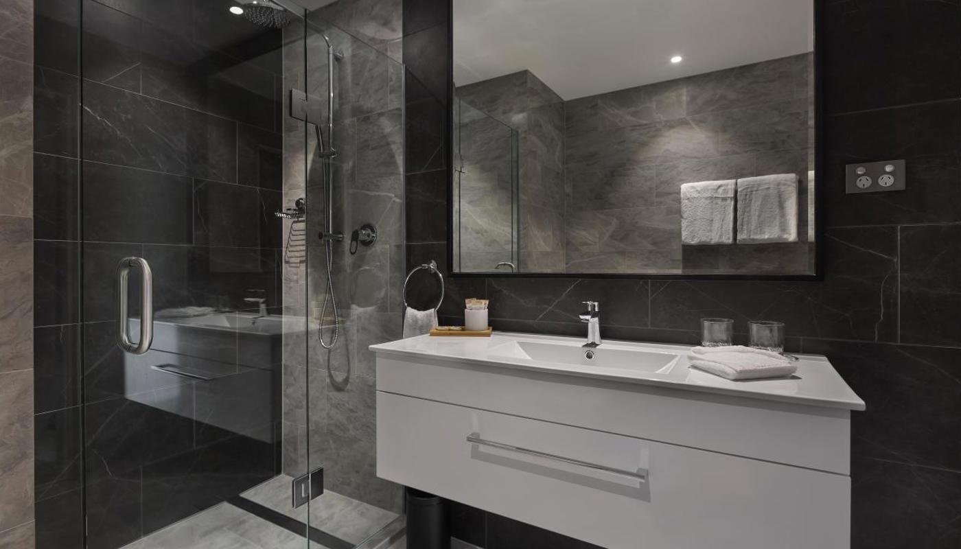 Deluxe bathrooms feature rain shower